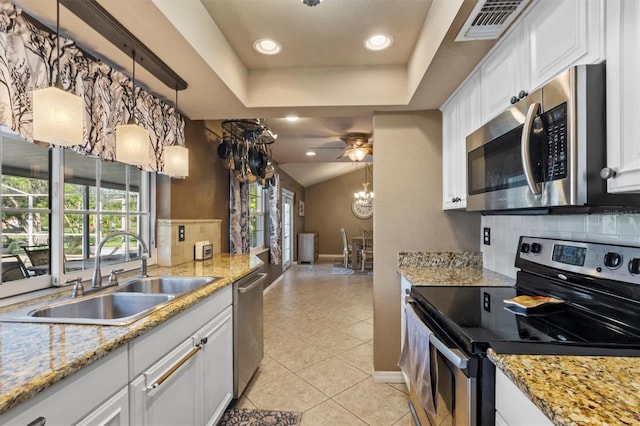 kitchen with sink, tasteful backsplash, white cabinetry, and appliances with stainless steel finishes