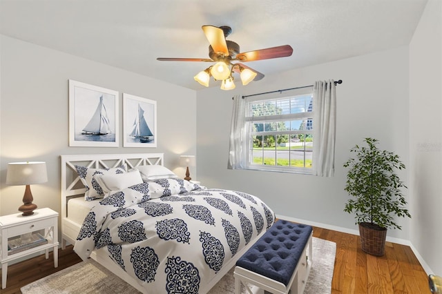 bedroom with wood-type flooring and ceiling fan