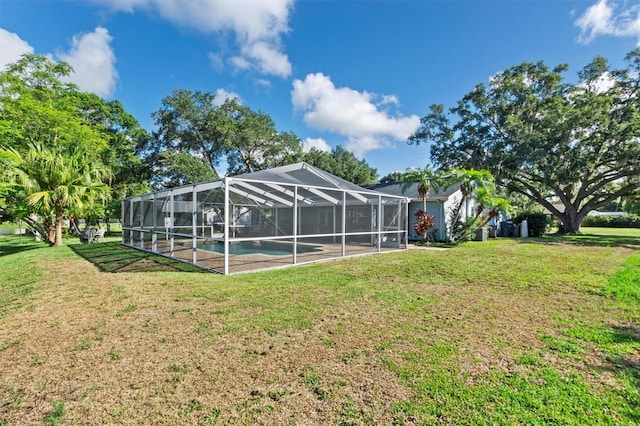 view of yard with glass enclosure