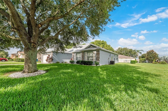 view of side of property featuring a lawn and central air condition unit