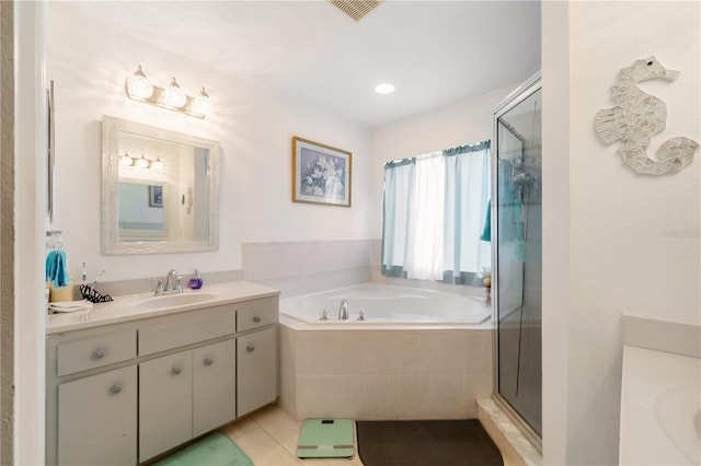 bathroom with vanity, tile patterned flooring, and shower with separate bathtub