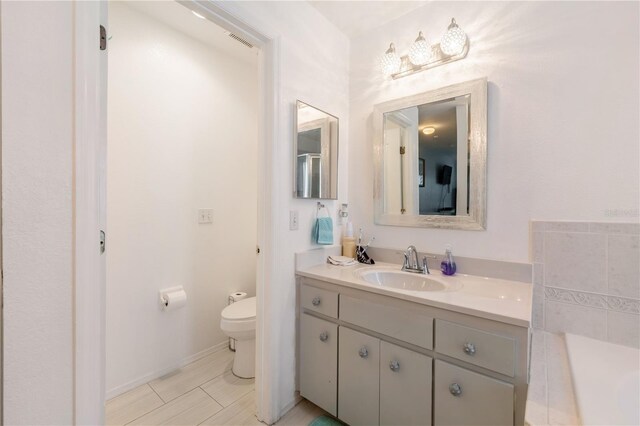 bathroom with vanity and toilet