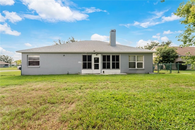 back of house with a yard