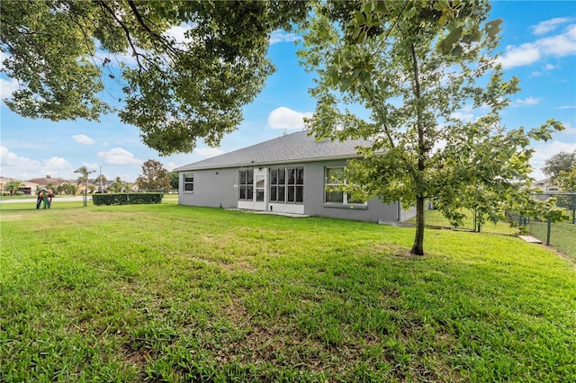 rear view of house with a lawn