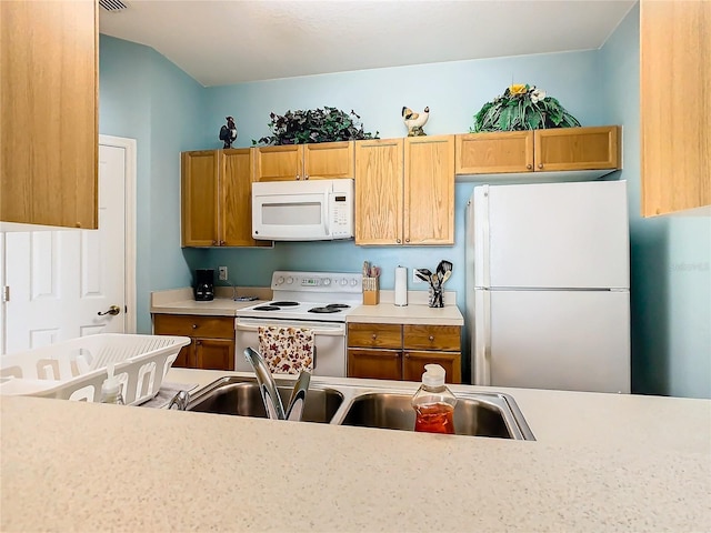 kitchen with sink and white appliances