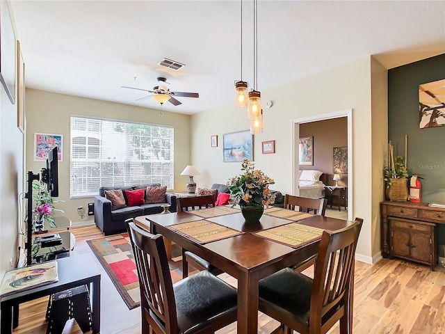 dining space featuring ceiling fan and light wood-type flooring