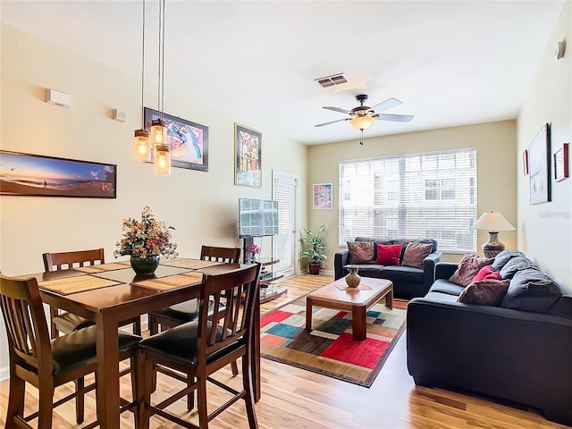 living room featuring ceiling fan and light hardwood / wood-style floors