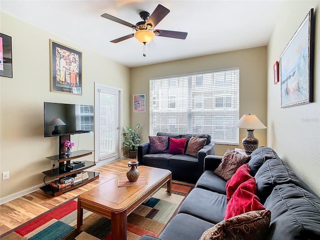 living room featuring ceiling fan and light wood-type flooring