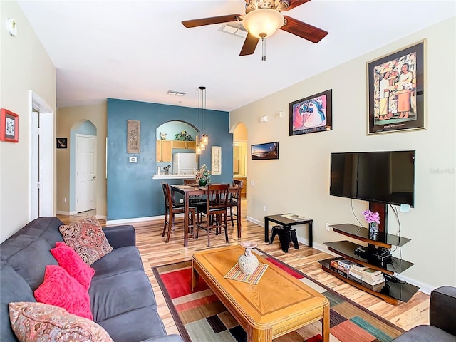 living room featuring wood-type flooring and ceiling fan