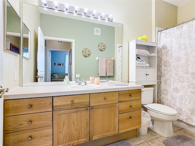 bathroom with vanity, tile patterned floors, and toilet