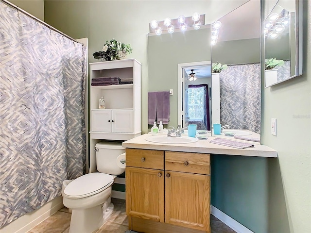 bathroom featuring tile patterned flooring, vanity, and toilet