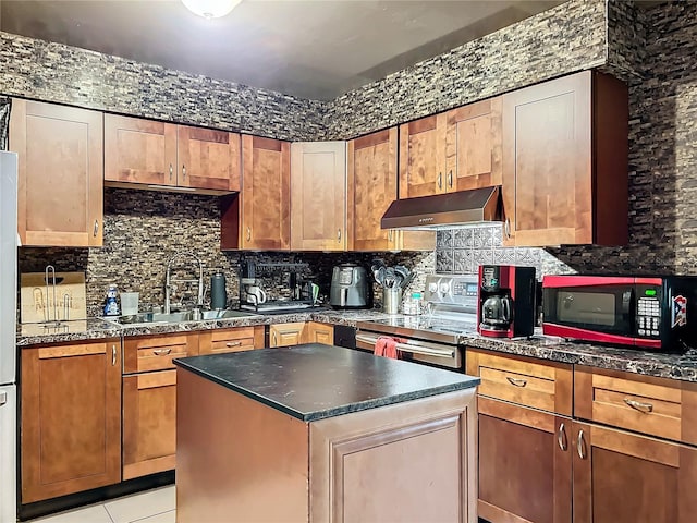 kitchen featuring light tile patterned floors, backsplash, a kitchen island, stainless steel range with electric cooktop, and sink