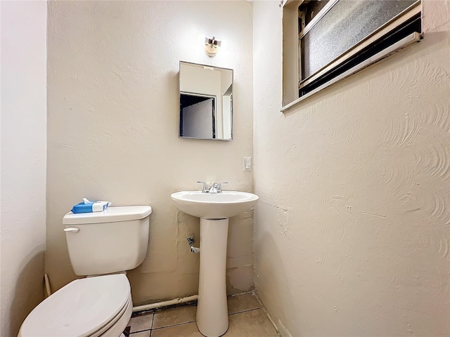 bathroom with tile patterned flooring and toilet