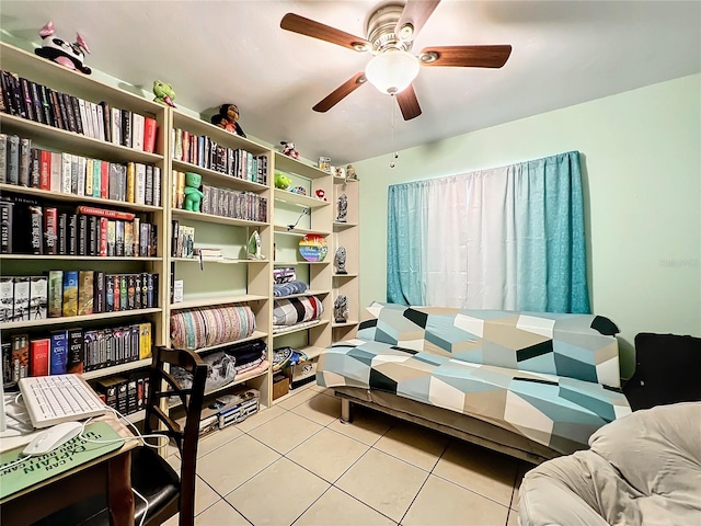 living area with ceiling fan and tile patterned floors