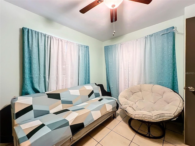 bedroom with ceiling fan and tile patterned flooring