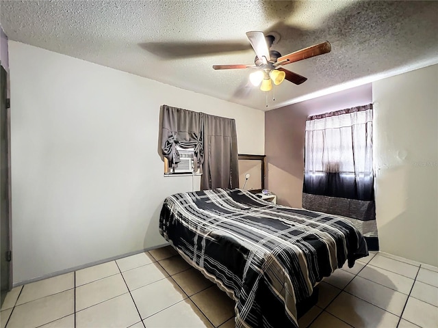 tiled bedroom with a textured ceiling and ceiling fan