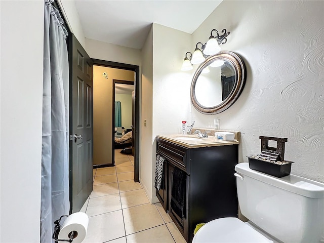 bathroom featuring tile patterned floors, toilet, and vanity