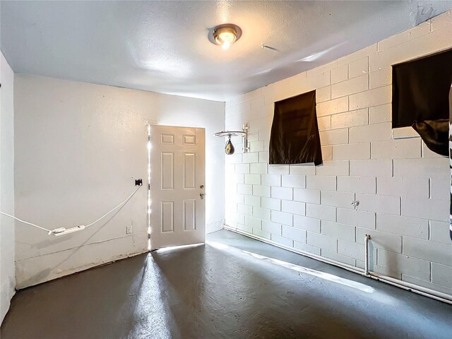 entrance foyer with a textured ceiling and concrete floors