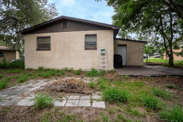 view of side of home with a patio