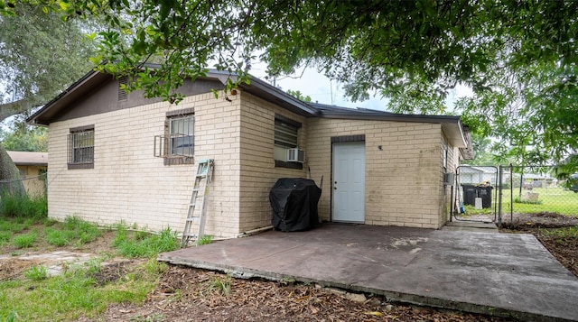 back of house with cooling unit and a patio area