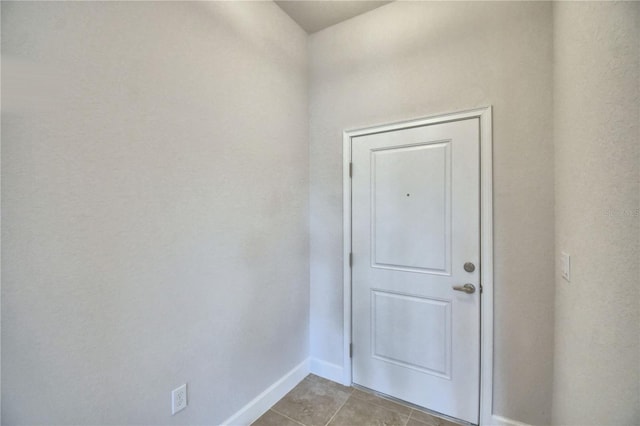 doorway with light tile patterned flooring