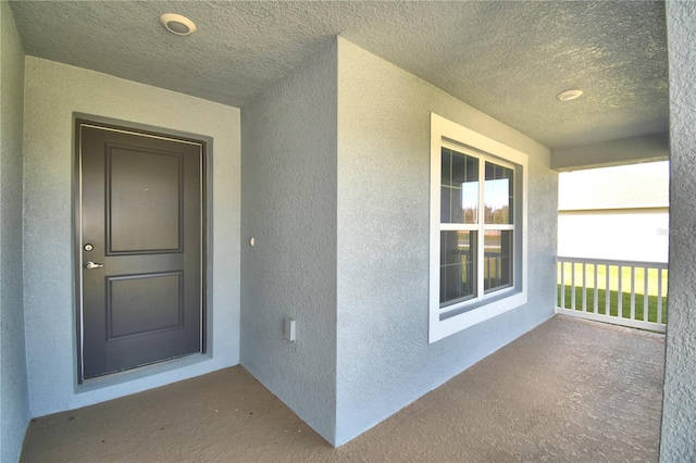 view of exterior entry with a porch