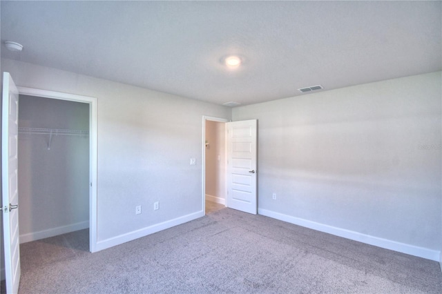 unfurnished bedroom featuring carpet flooring and a closet