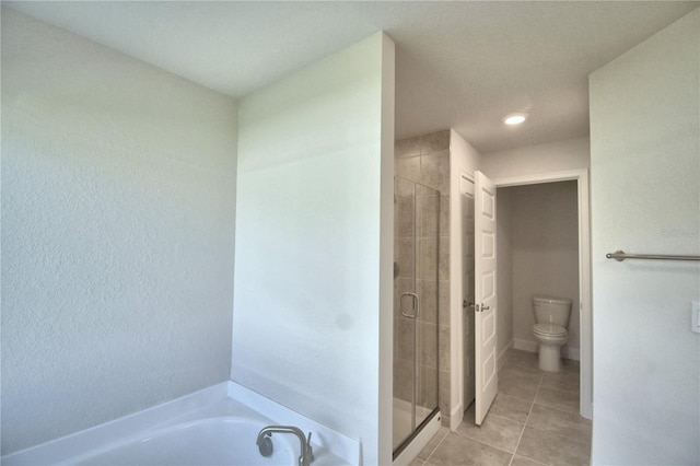 bathroom featuring tile patterned floors, shower with separate bathtub, and toilet