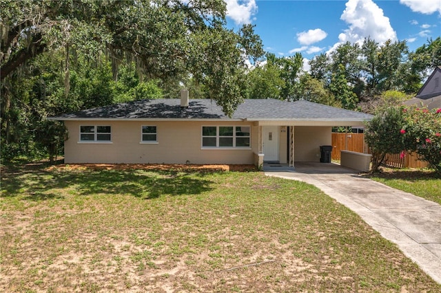 ranch-style home with a carport and a front lawn