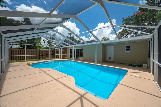 view of swimming pool featuring a lanai and a patio