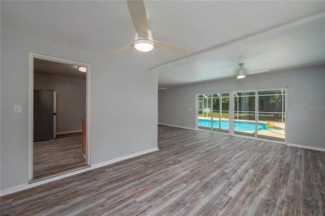 spare room with hardwood / wood-style floors and ceiling fan