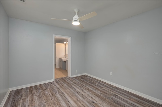 empty room with light hardwood / wood-style flooring and ceiling fan