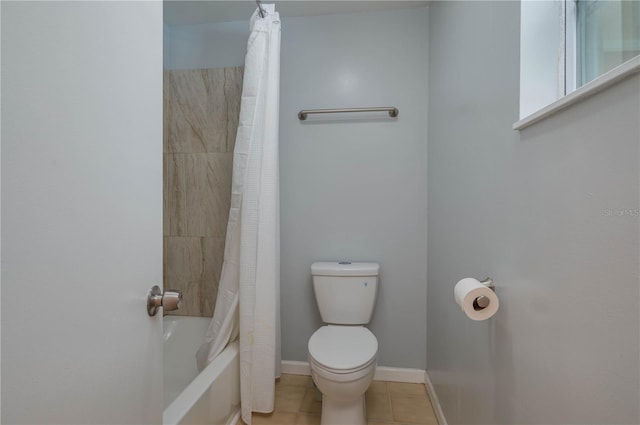 bathroom with toilet, tile patterned flooring, and shower / tub combo