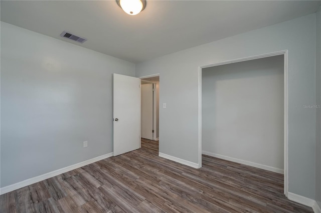 unfurnished bedroom featuring dark hardwood / wood-style floors