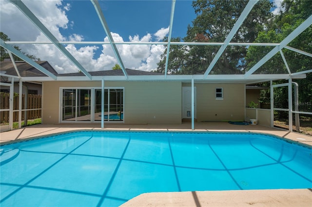 view of swimming pool with a patio and glass enclosure