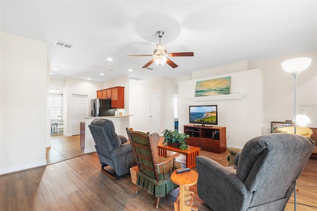 living area featuring ceiling fan, wood finished floors, visible vents, and recessed lighting