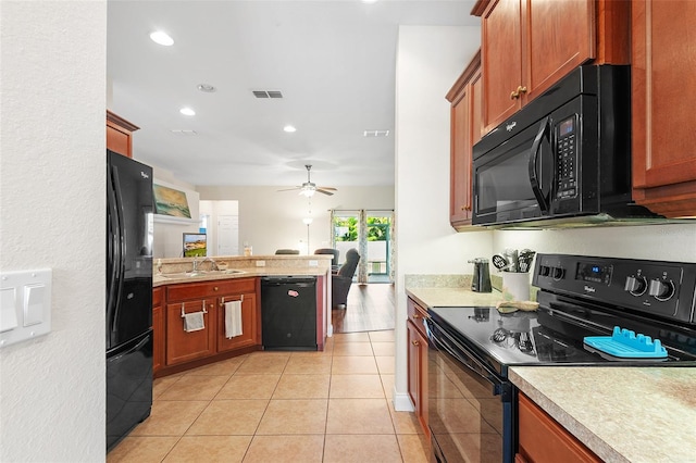 kitchen with light tile patterned floors, visible vents, a peninsula, light countertops, and black appliances