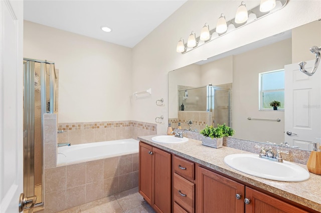 full bathroom with a stall shower, tile patterned floors, a sink, and a bath