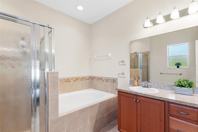 full bath with a garden tub, vanity, and a shower stall