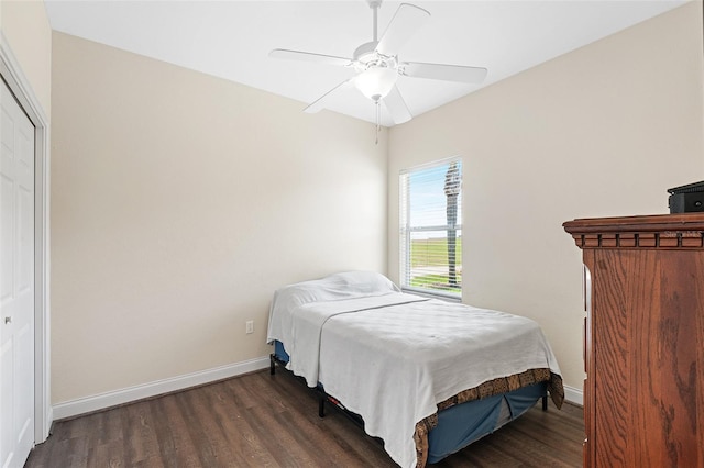 bedroom featuring ceiling fan, baseboards, and wood finished floors