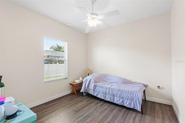 bedroom with ceiling fan, wood finished floors, and baseboards