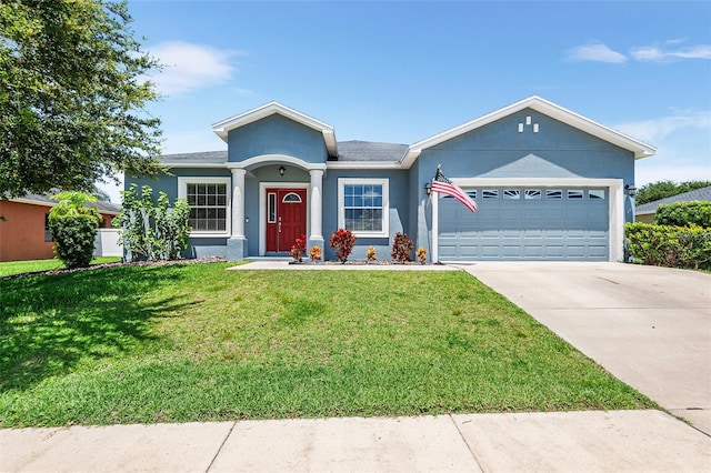 ranch-style house featuring a garage and a front lawn