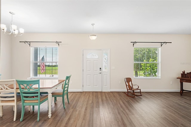 entryway with an inviting chandelier, wood finished floors, and baseboards