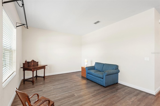 living area featuring baseboards and wood finished floors