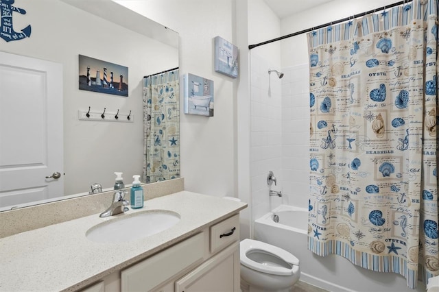 full bathroom with vanity, shower / tub combo, and toilet