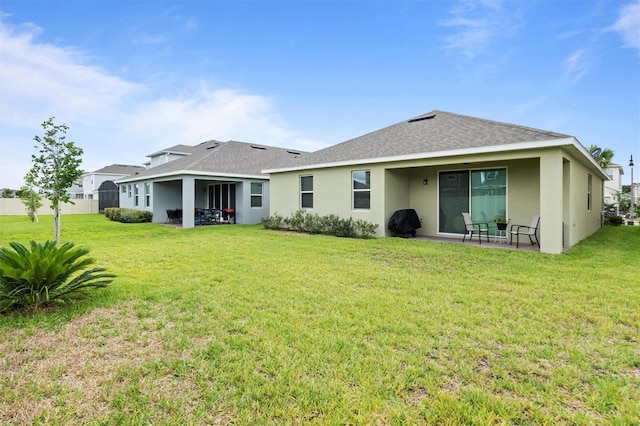 back of house featuring a yard and a patio