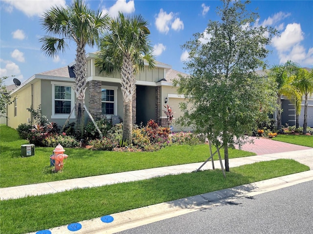 view of front of property with a garage and a front lawn