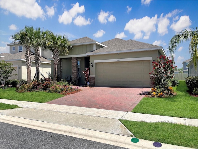 view of front of house with a front lawn and a garage