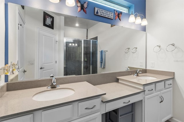 bathroom with vanity and a shower with door