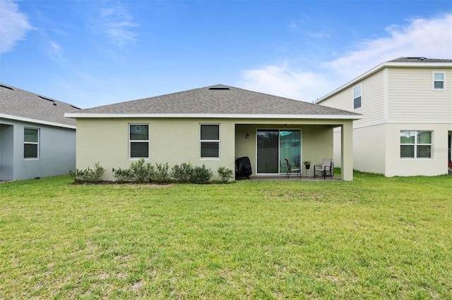 back of property featuring a yard and a patio area